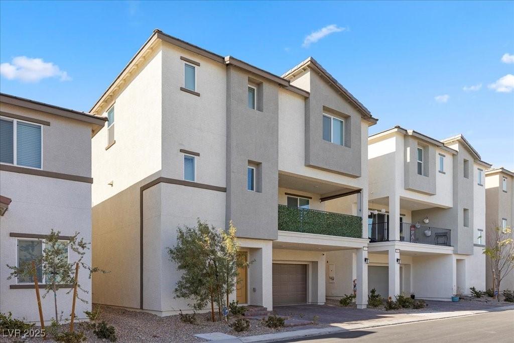 Image 2: Back of house featuring stucco siding, a balcony,