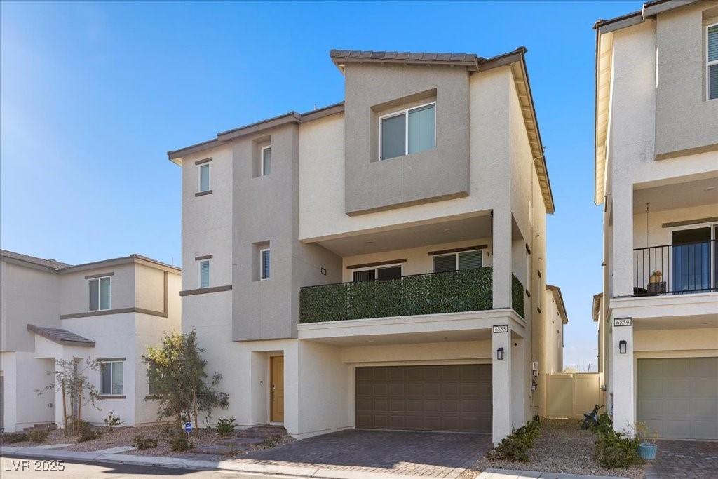 Image 3: View of front of house featuring stucco siding, a