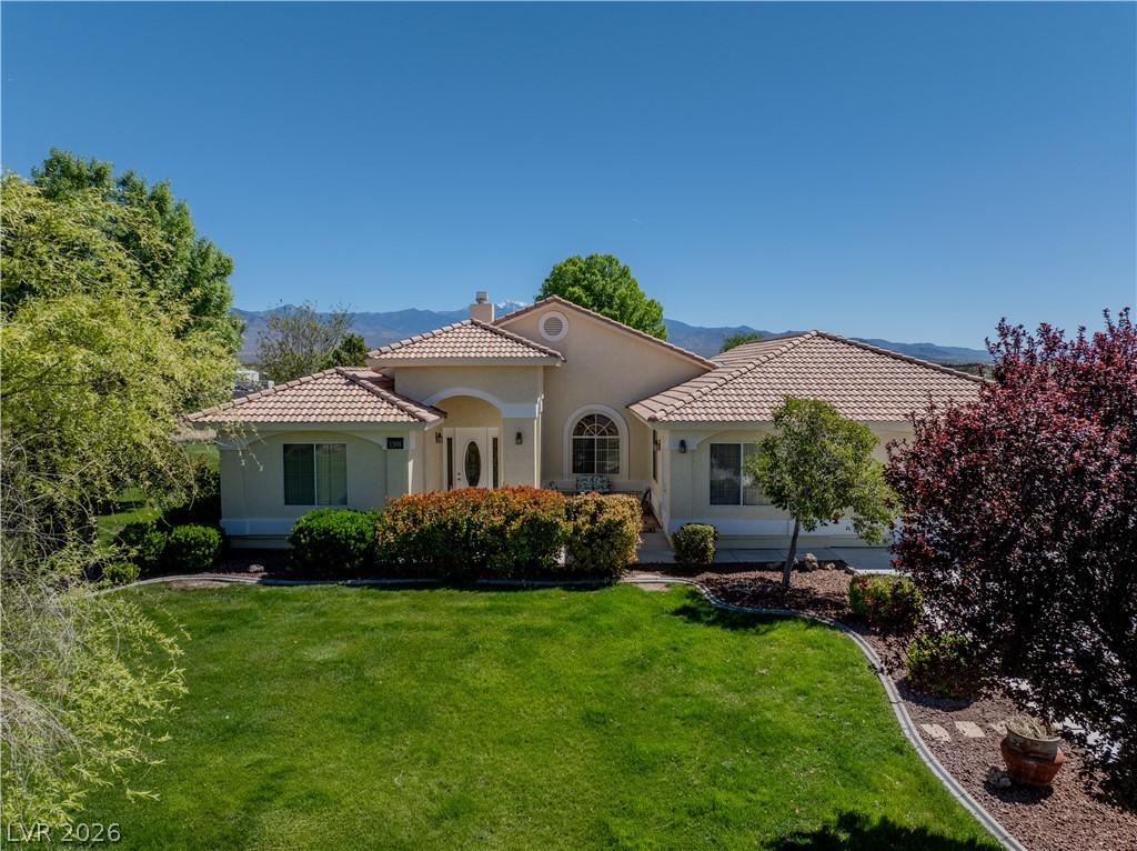 Image 4: Mediterranean / spanish house with a front yard, a