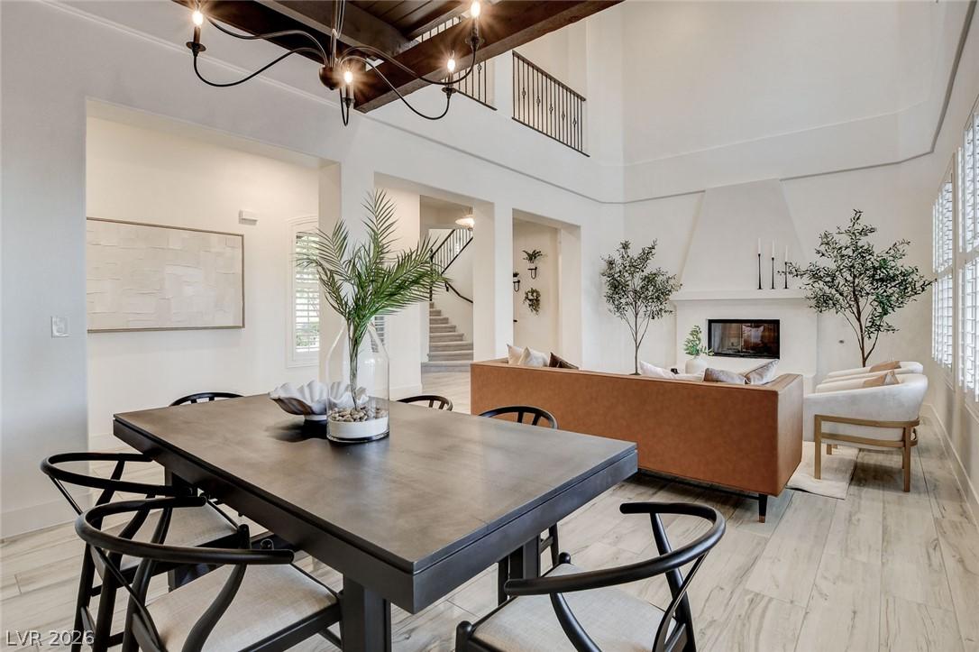 Image 3: Architectural ceiling beams and an open-concept la
