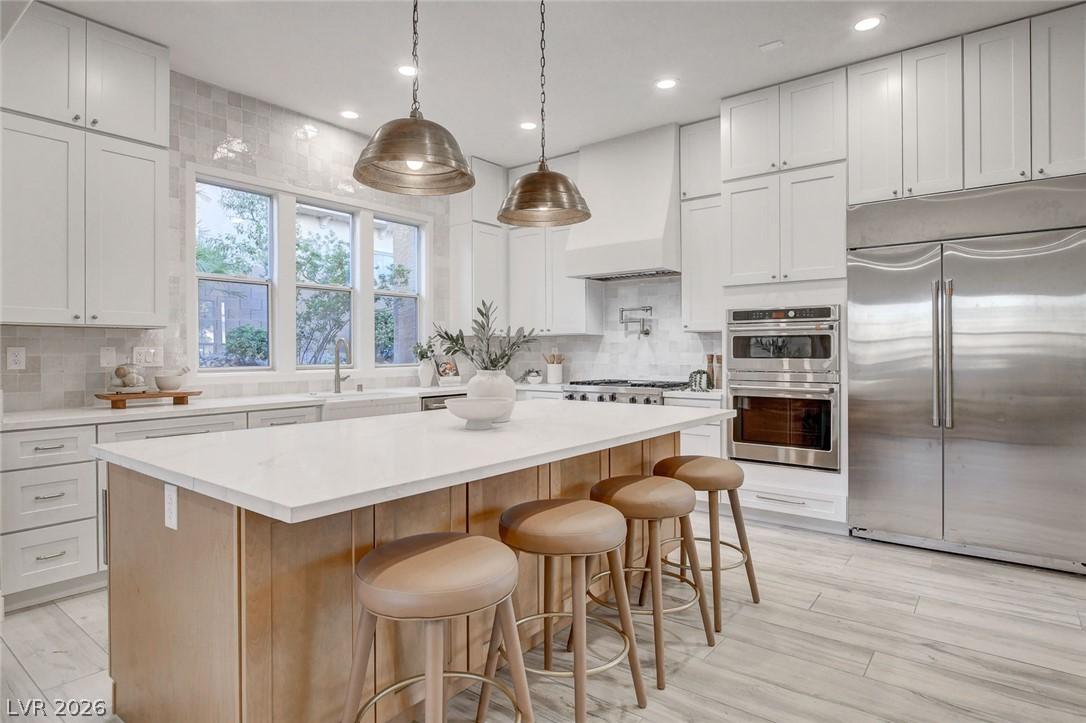 Image 4: An inviting kitchen features a large island and am