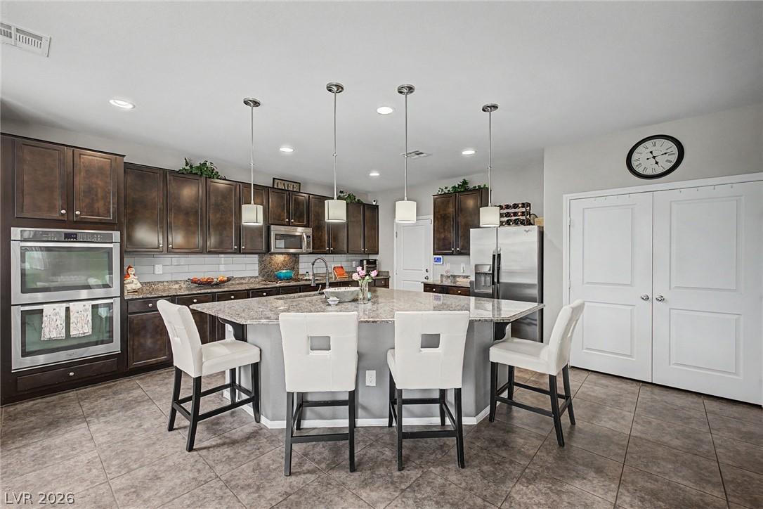 Image 2: A generous kitchen island provides ample counter s