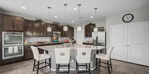 Image 2: A generous kitchen island provides ample counter s