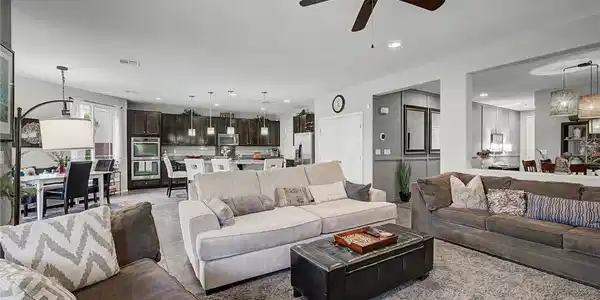 Image 3: An inviting open-concept living area flows seamles