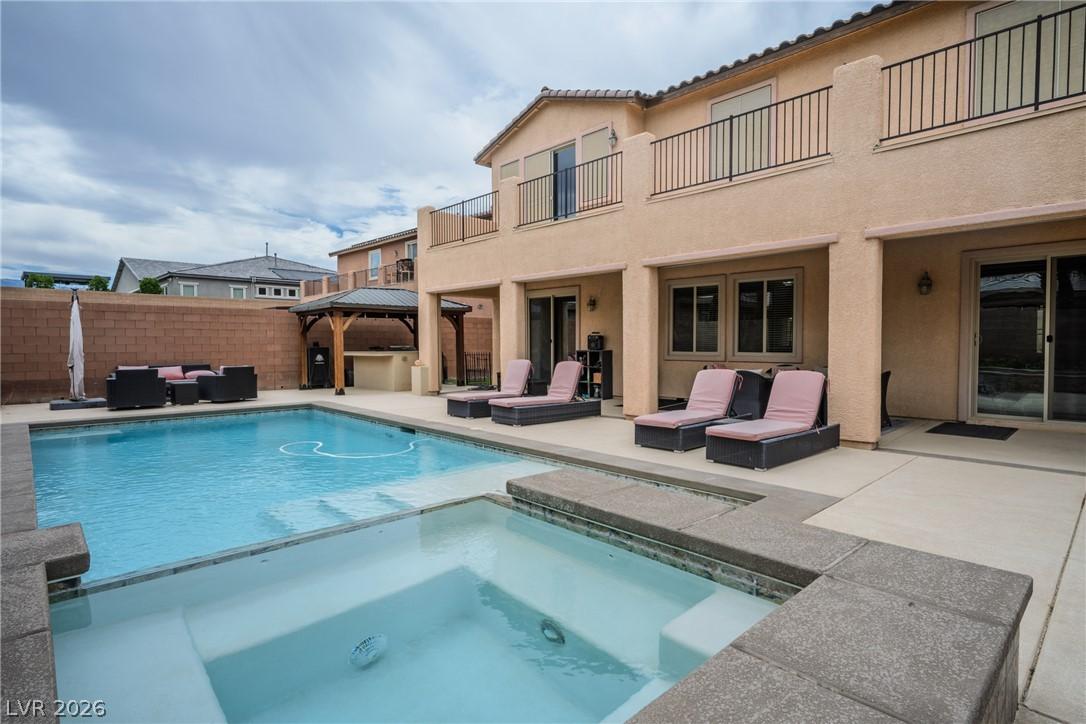 Image 2: An inviting backyard oasis offers a sparkling pool