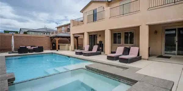 Image 2: An inviting backyard oasis offers a sparkling pool