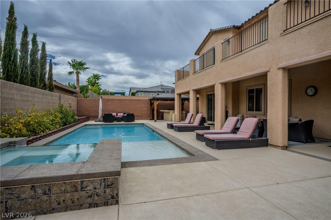 Image 3: A private backyard oasis features an inviting pool