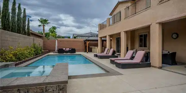 Image 3: A private backyard oasis features an inviting pool