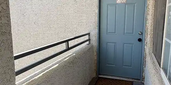 Image 2: Welcome home through a robust blue entry door, off