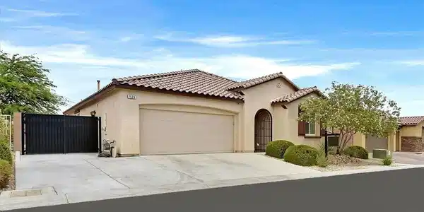 Image 2: A well-kept, single-story home with a tiled roof a