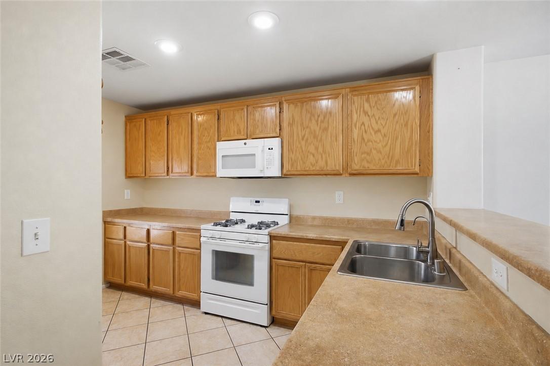 Image 4: A functional kitchen features warm wood cabinetry