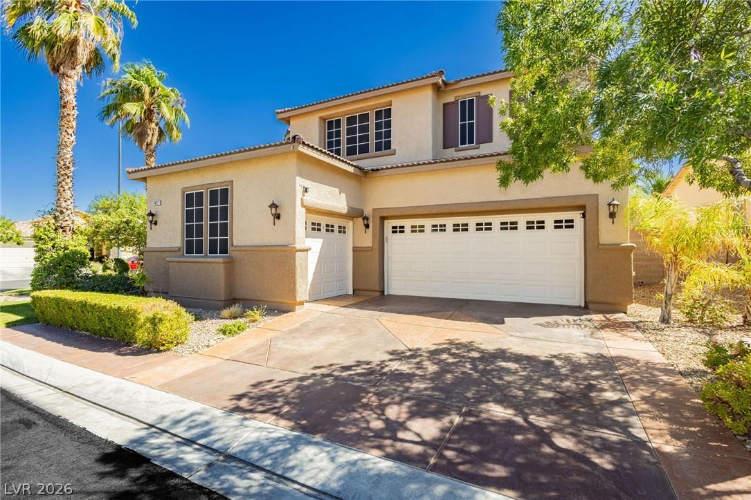 Image 2: A well-maintained stucco home with a two-car garag