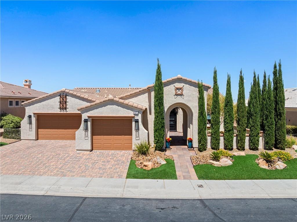 Image 2: A welcoming arched entryway and elegant landscapin