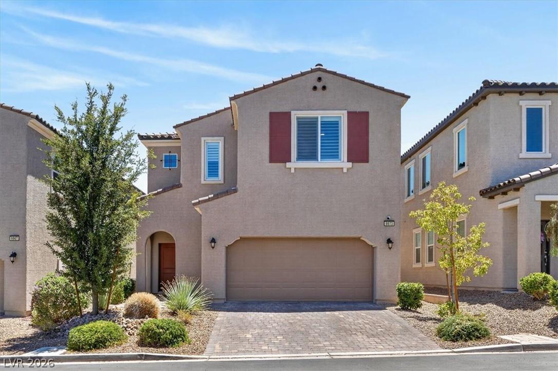 Image 1: A desert-friendly landscape accents the stucco fac