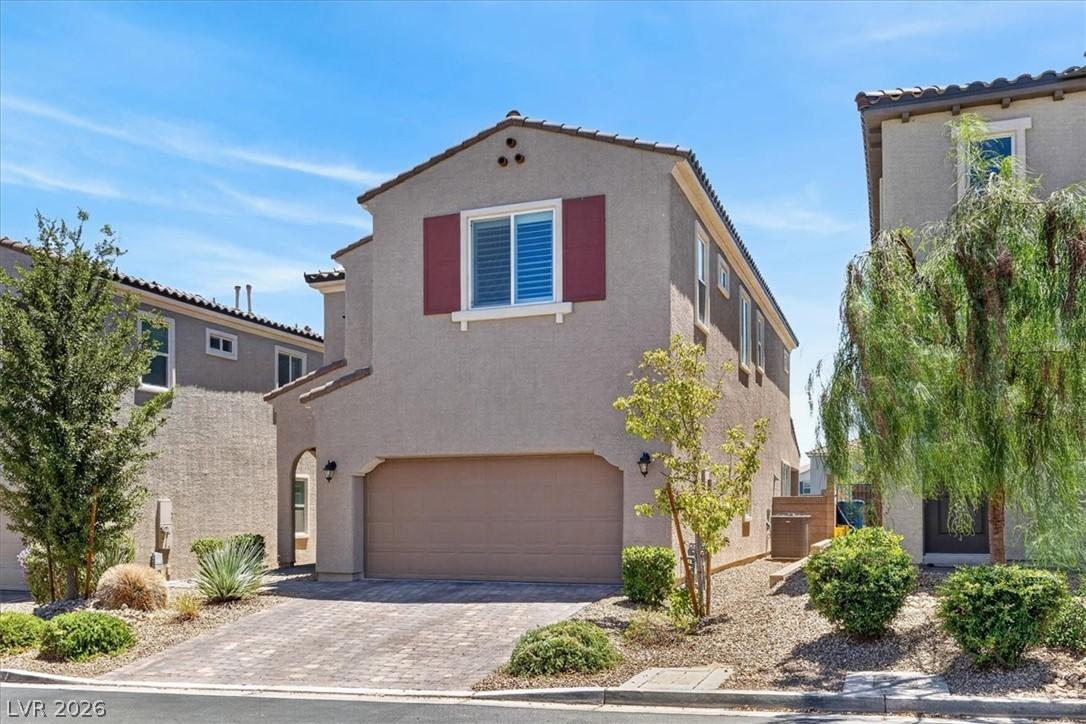 Image 2: A charming stucco home with a terracotta tile roof