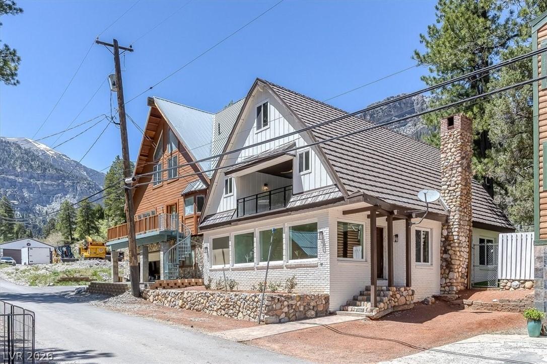Image 1: This charming home offers mountain views and a coz
