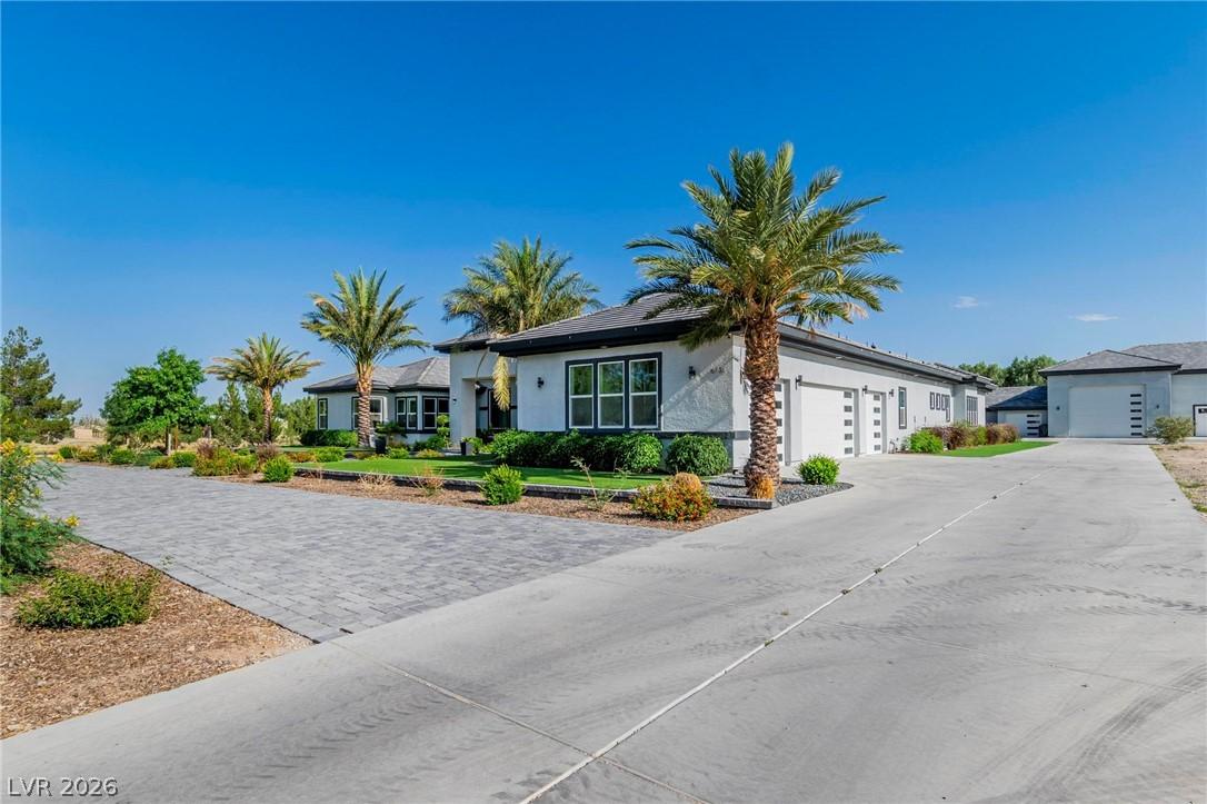 Image 2: Ranch-style house featuring stucco siding, concret