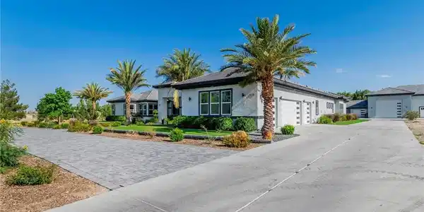 Image 2: Ranch-style house featuring stucco siding, concret