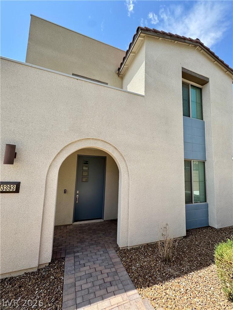 Image 4: An inviting arched entryway guides to a modern fro