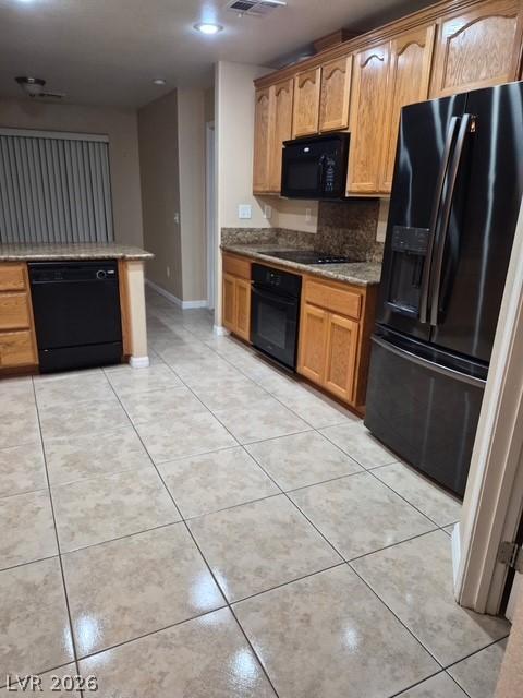 Image 3: A well-appointed kitchen features warm wooden cabi