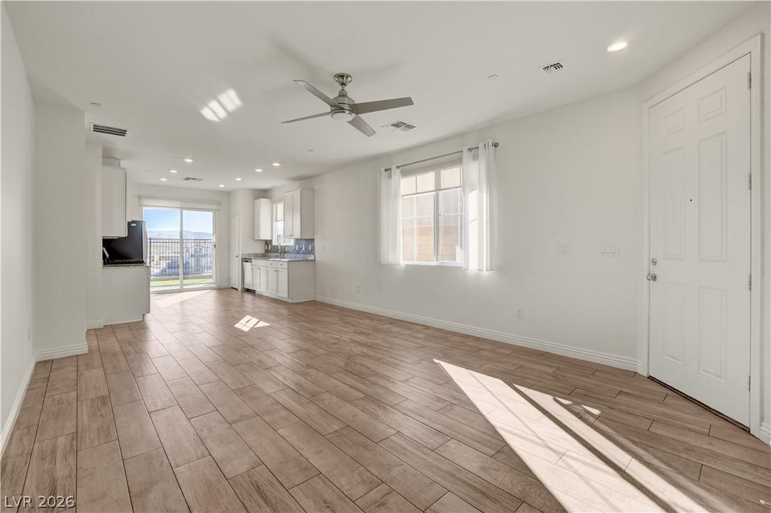 Image 4: Open-concept living area with abundant natural ill