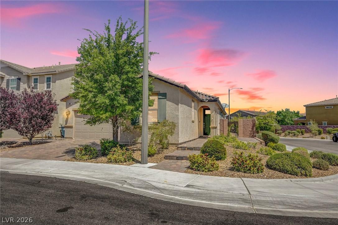 Image 2: This charming home features a stucco exterior and