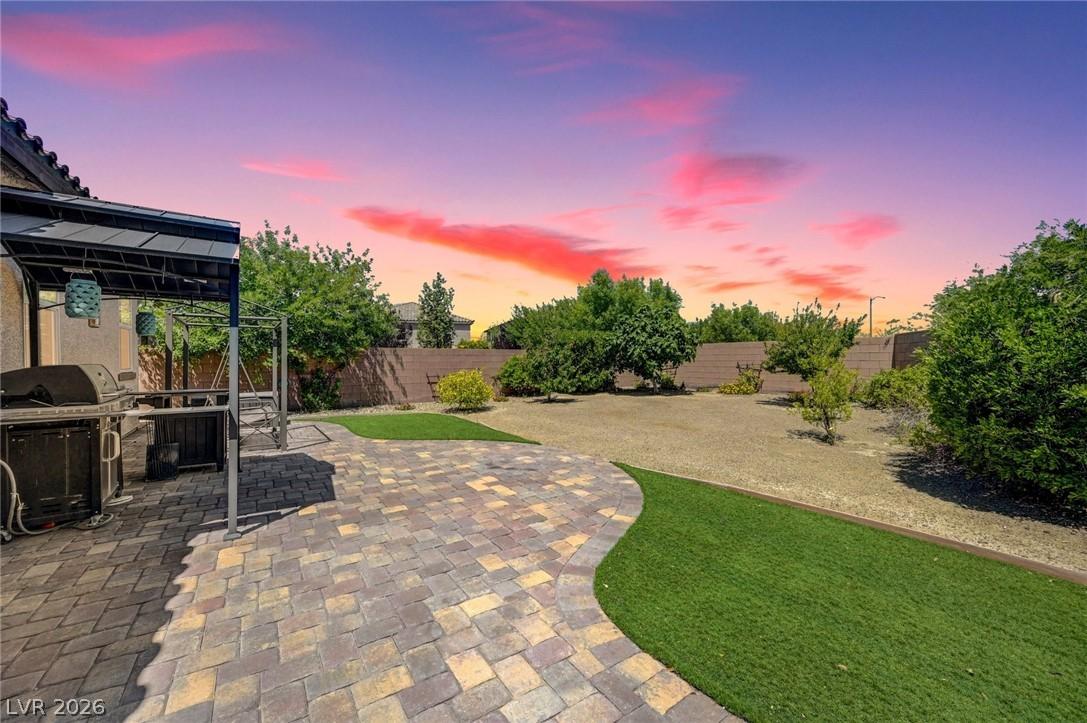 Image 3: This spacious backyard features a paved patio, per