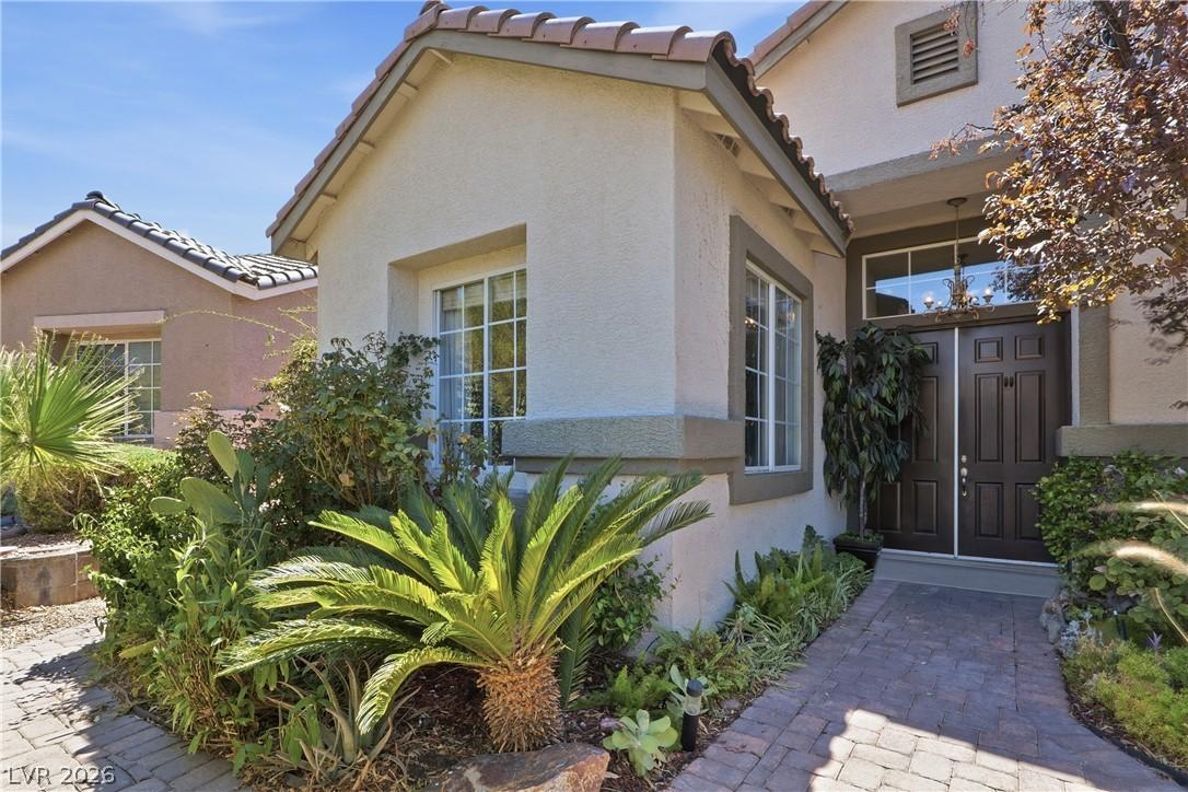 Image 3: A welcoming paver walkway leads to a grand double