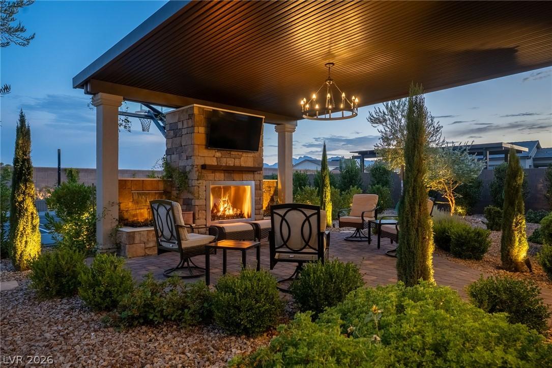 Image 3: An inviting outdoor living space features a cozy f