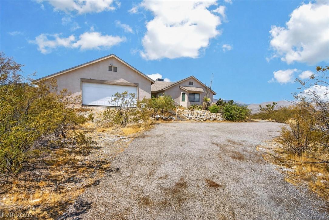 Image 4: A spacious desert dwelling with an attached garage