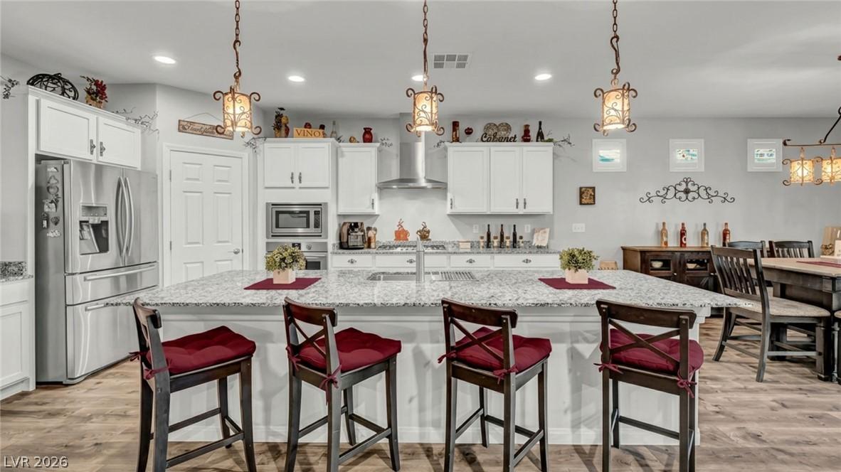 Image 2: A well-appointed kitchen features a large island w