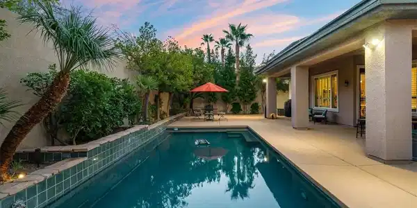 Image 2: An inviting swimming pool anchors this private bac