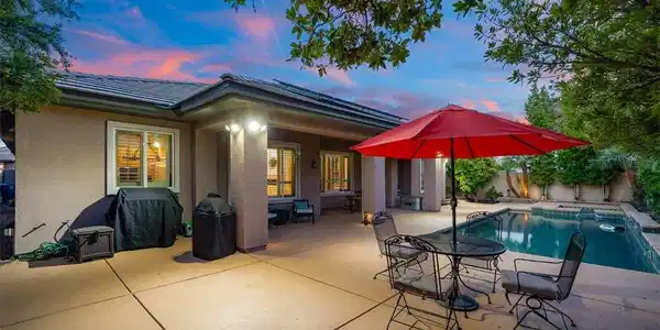 Image 3: An inviting backyard patio sits adjacent to a spar