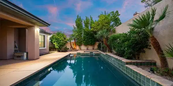 Image 4: An inviting backyard oasis features a shimmering s