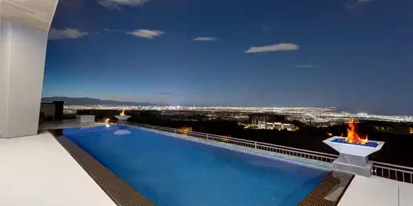Image 3: An infinity pool looks out over sweeping city ligh