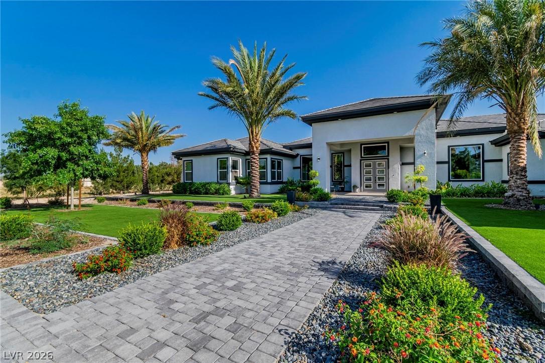 Image 4: Prairie-style home with a front yard, stucco sidin