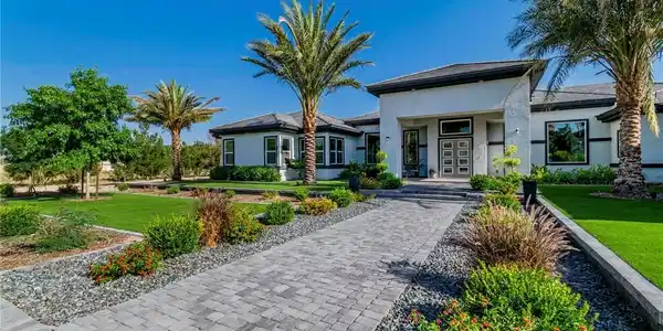 Image 4: Prairie-style home with a front yard, stucco sidin