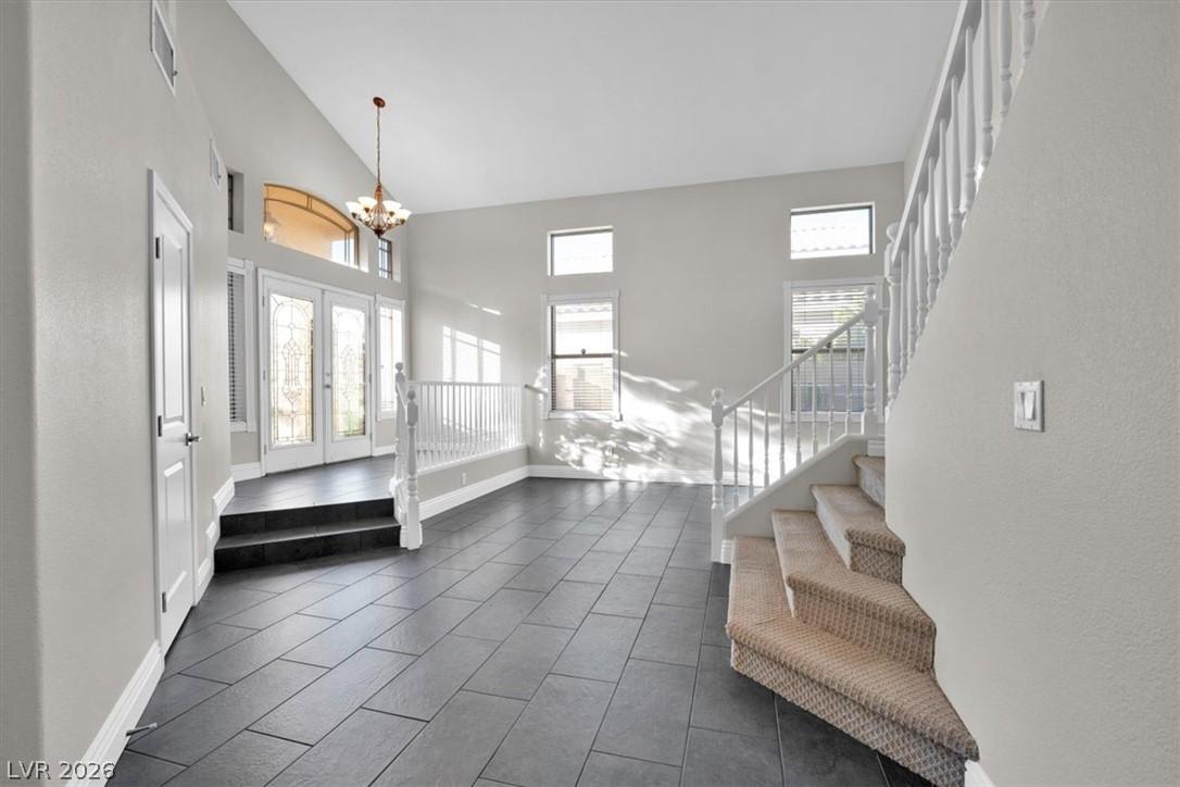 Image 4: A grand entrance with soaring ceilings and an eleg