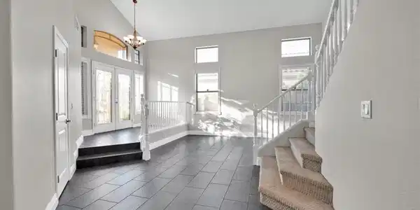 Image 4: A grand entrance with soaring ceilings and an eleg
