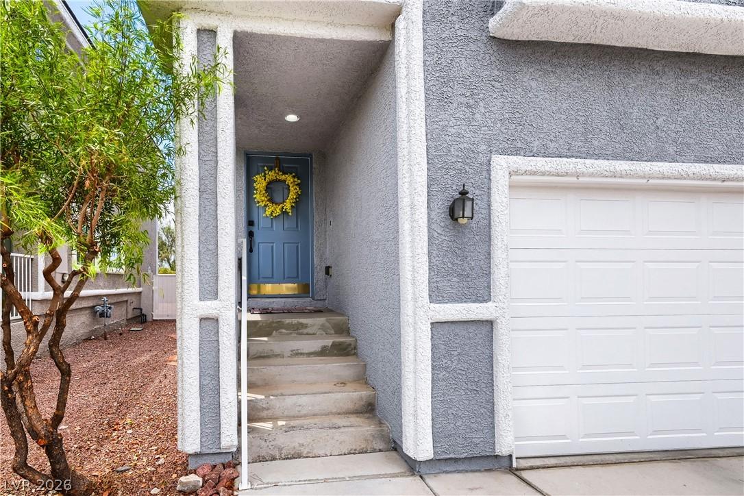 Image 2: An inviting entrance with a bold blue door and whi
