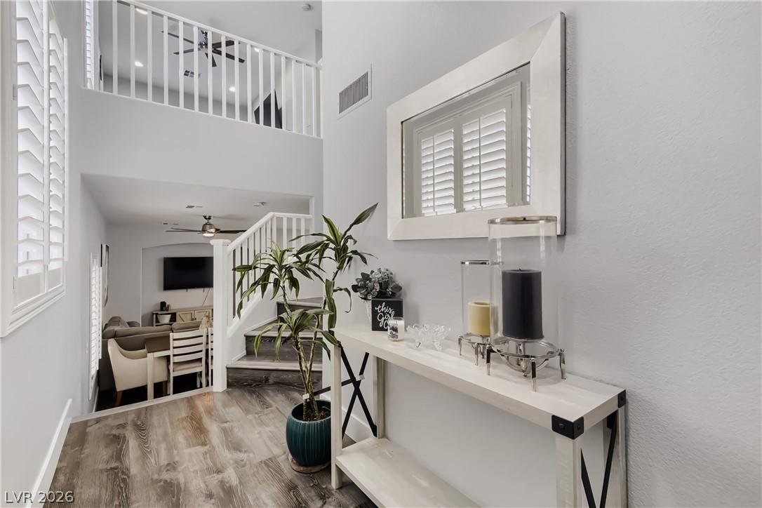 Image 4: A split-level entry hall boasts soaring ceilings,