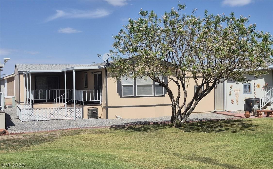 Image 4: A flowering tree shades the well-kept lawn, enhanc