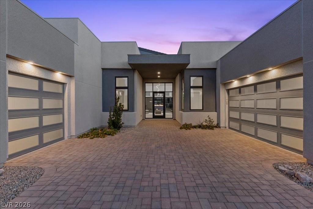 Image 4: A striking modern facade with ample garage space a