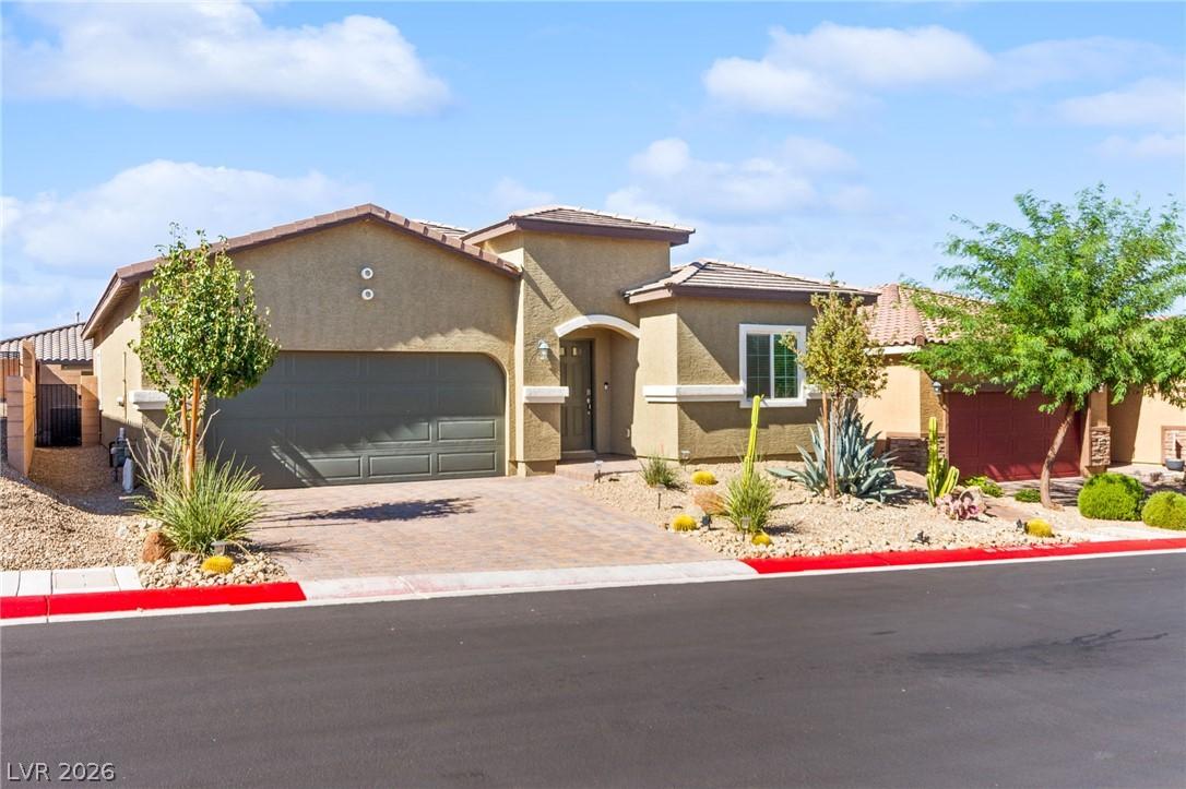 Image 2: A desert-friendly facade with a paver driveway, ac