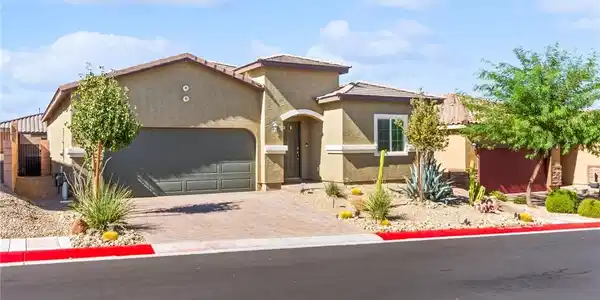 Image 2: A desert-friendly facade with a paver driveway, ac