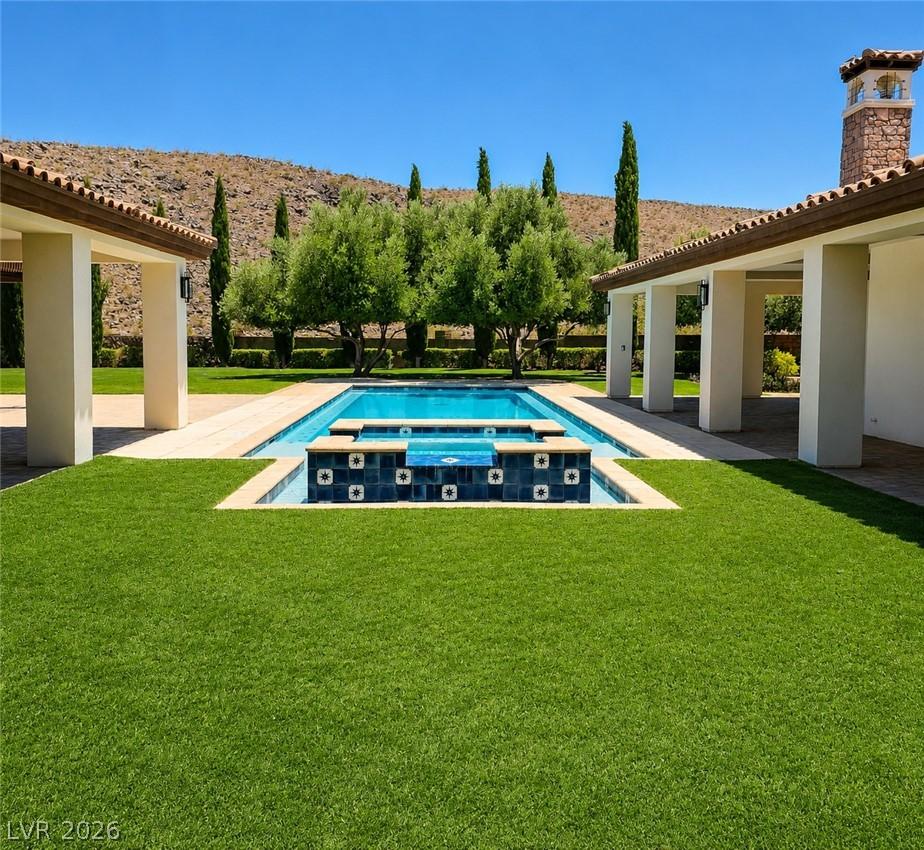 Image 2: Your inviting backyard oasis features a fully remo