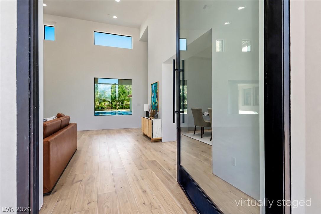 Image 3: A grand entrance through a modern glass pivot door