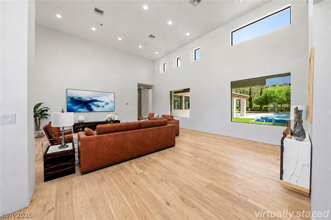 Image 4: Natural light pours into this grand living space w