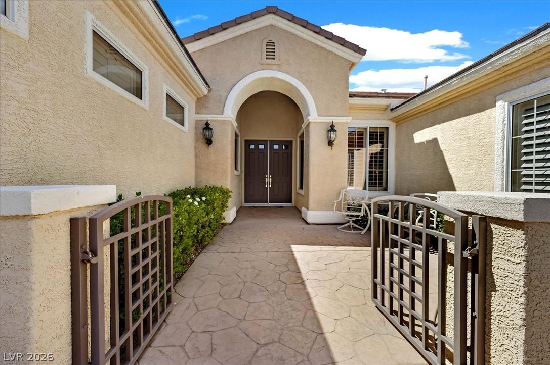 Image 4: Gated Stamped Concrete Courtyard Entry with lush G