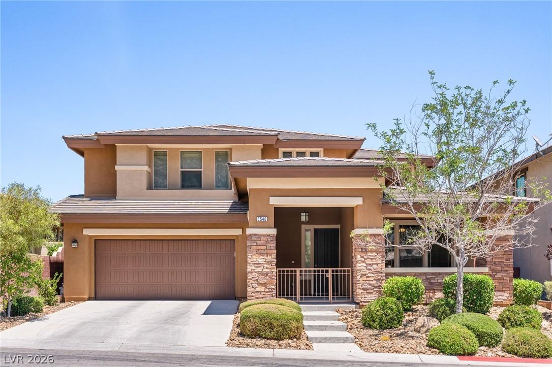 Image 2: Two-story home with a two-car garage features a st